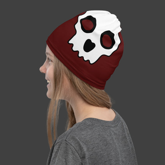 girl wearing a deep red neck gaiter with large skull prints as a beanie