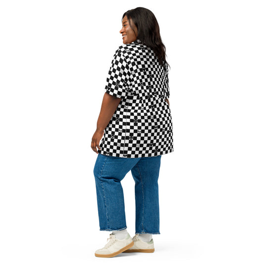 woman wearing a black and white checkered button up shirt wit emo symbols