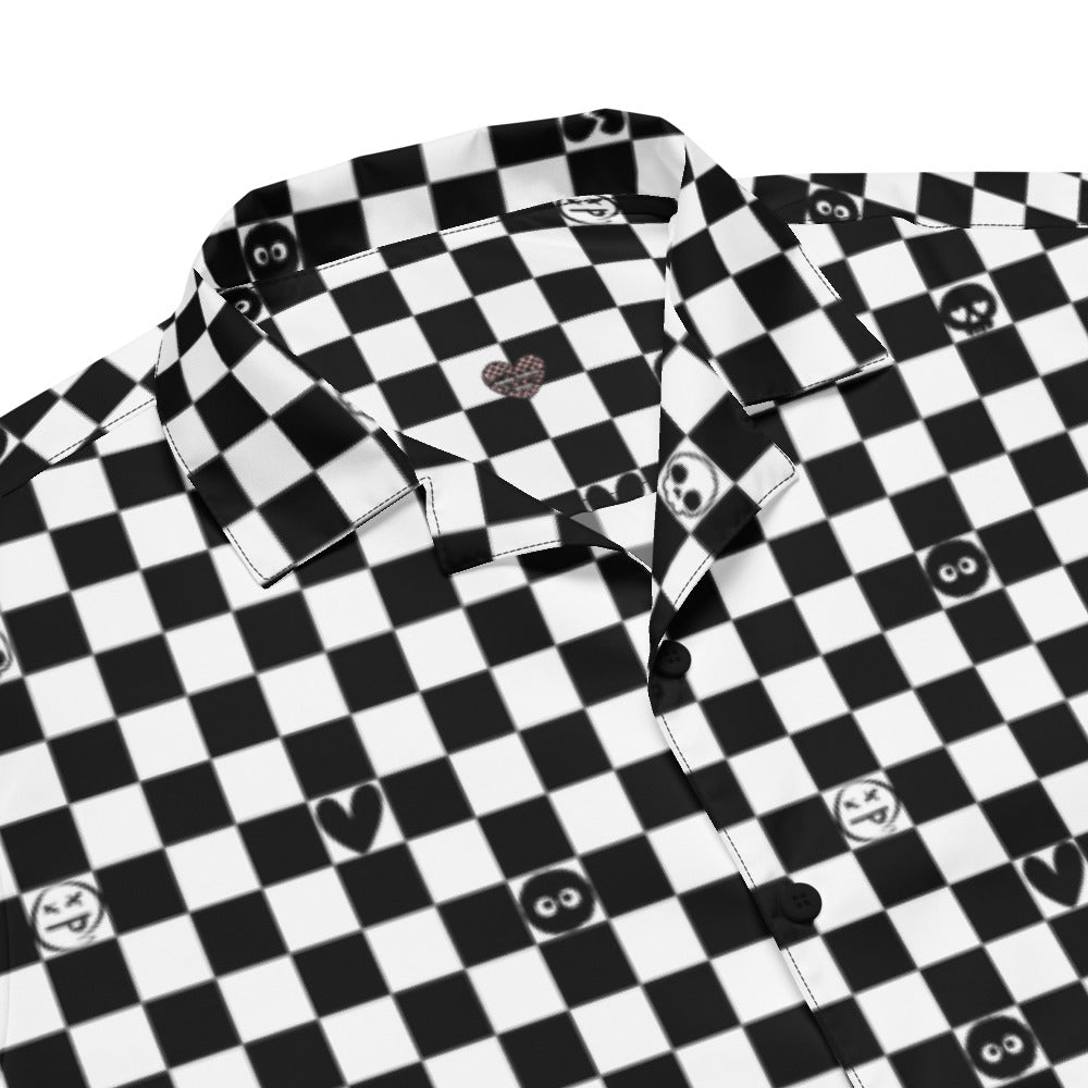detail of a black and white checkered button up shirt wit emo symbols