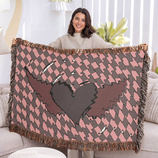 woman holding a woven blanket with a deep red heart with wings on a distorted checkered pattern