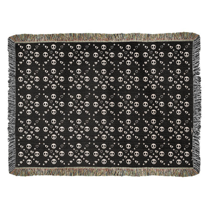 woven blanket with a geometric pattern of stitch mouth skulls 