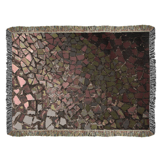 A woven blanket with deep red, black and lighter color shattered mosaic image