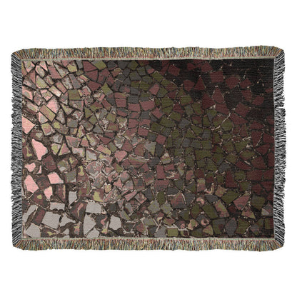 A woven blanket with deep red, black and lighter color shattered mosaic image