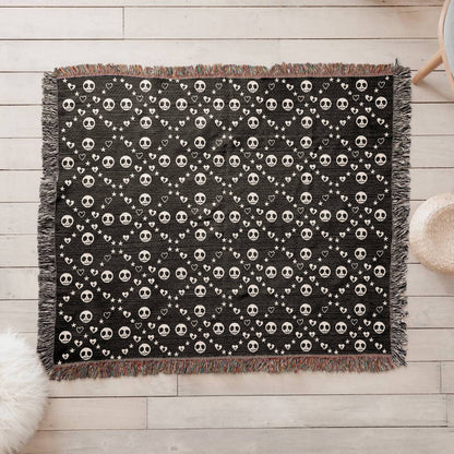 woven blanket with a geometric pattern of stitch mouth skulls 