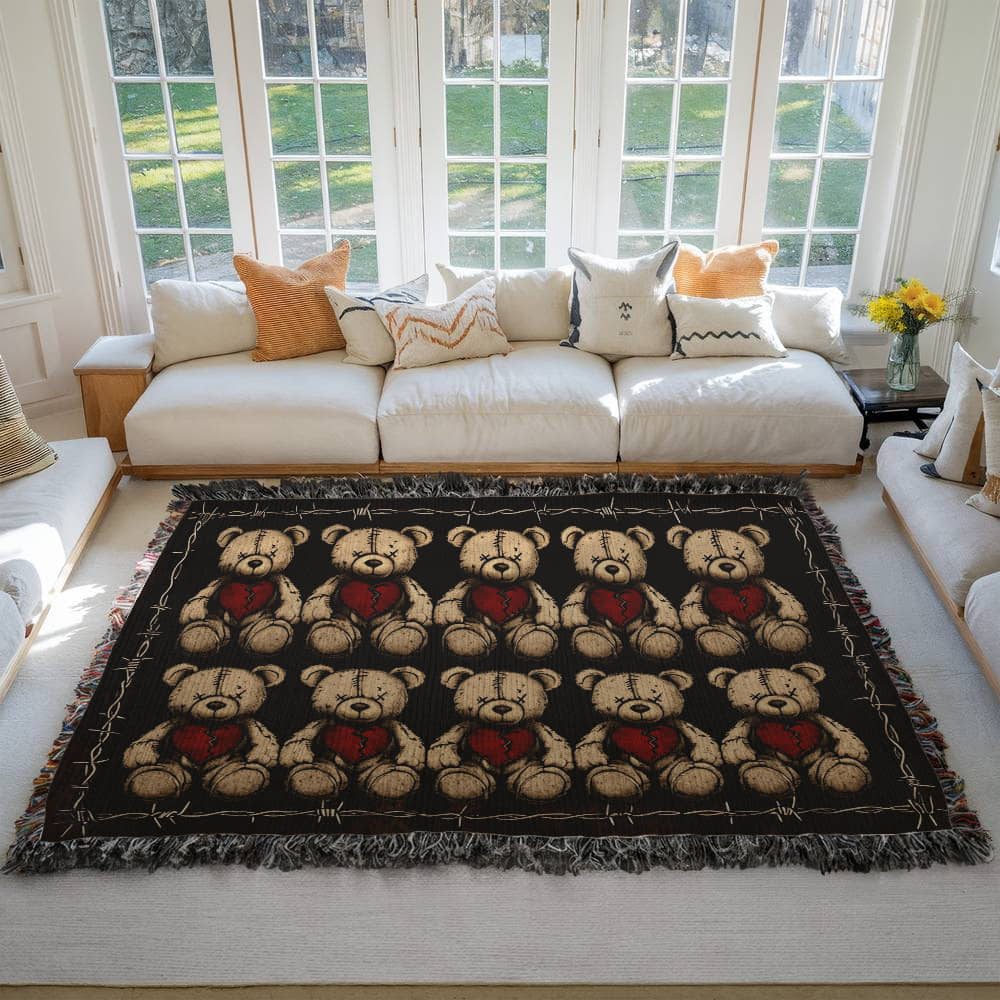 a woven blanket with x-eyed teddy bears on a dark background and surrounded by a frame of barbed wire on a living room floor