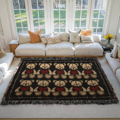 a woven blanket with x-eyed teddy bears on a dark background and surrounded by a frame of barbed wire on a living room floor