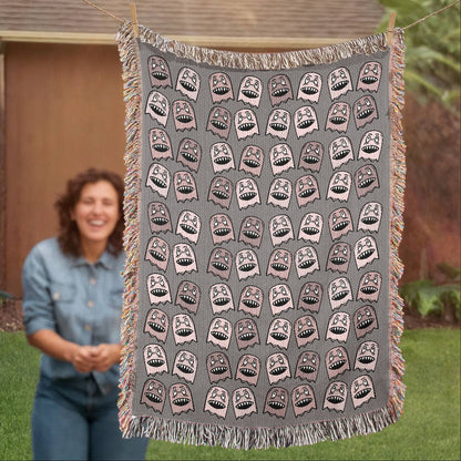 a woven blanket with a purplish grey and pink goblin pattern