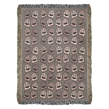 a woven blanket with a purplish grey and pink goblin pattern