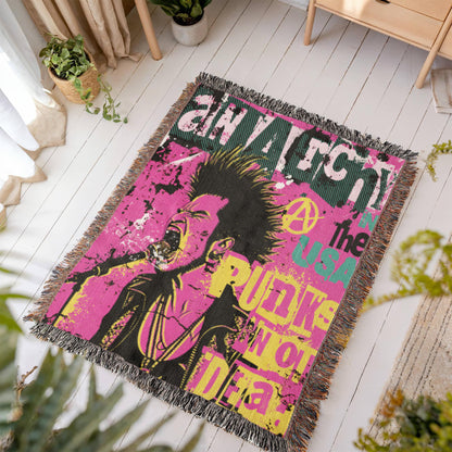 a woven blanket with a punk collage in pink black and yellow and text anarchy in the usa