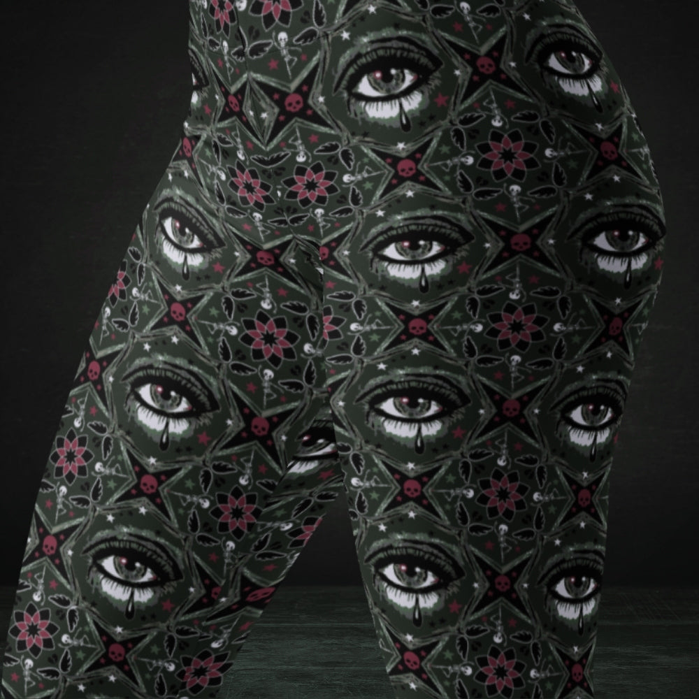 Green kaleidoscope like leggings with crying eyes and emo symbols