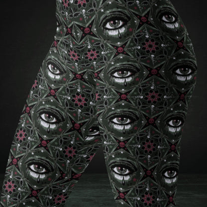 Green kaleidoscope like leggings with crying eyes and emo symbols