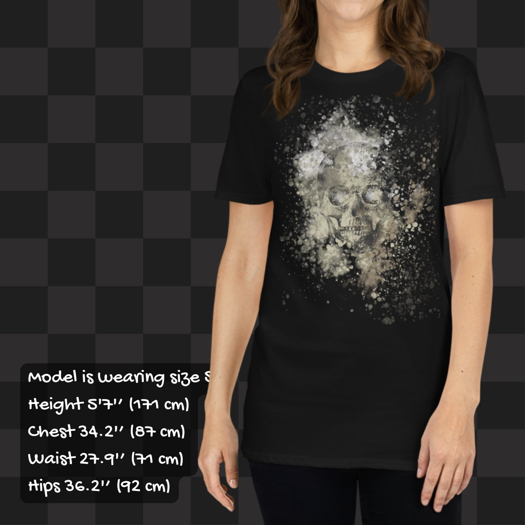 Person wearing a black tee with skull graphic surrounded and overlaid with paint splatter in camouflage colors