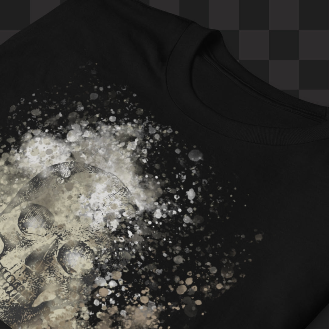 A black tee with skull graphic surrounded and overlaid with paint splatter in camouflage colors