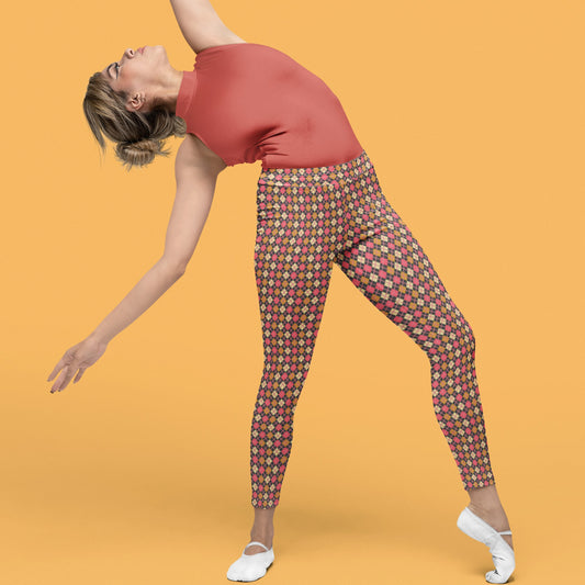 woman wearing leggings with diamond argyle pattern with charcoal base and pink accent