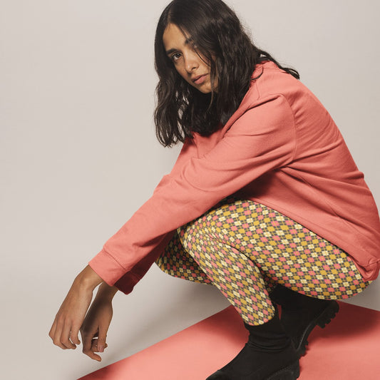 woman wearing leggings with diamond argyle pattern with charcoal base and yellow accent