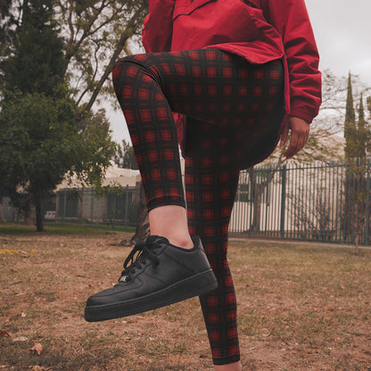 person wearing a darker red black version of the red plaid classic punk pattern leggings