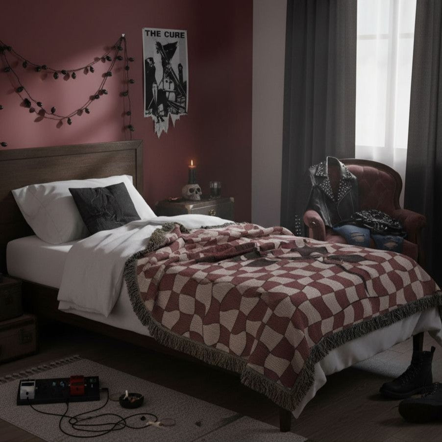 a woven blanket featuring dark romantic alt distorted checkerboard patterns and a deep red soulful rose used as bed throw