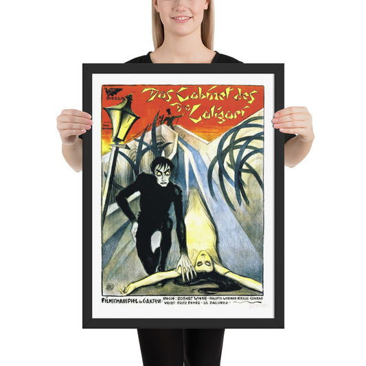 woman holding a framed vintage poster for the movie The Cabinet of Dr. Caligari 