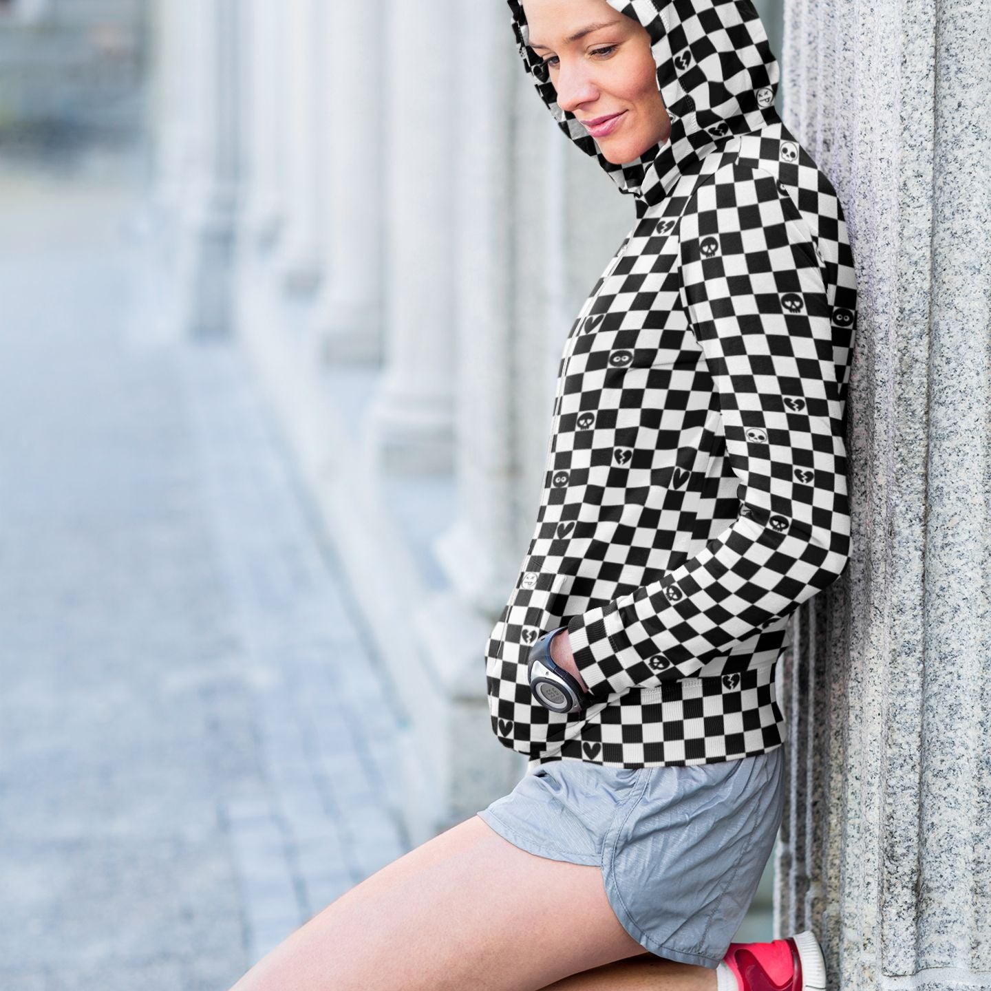 woman wearing a black and white checkered hoodie with emo symbols on some squares