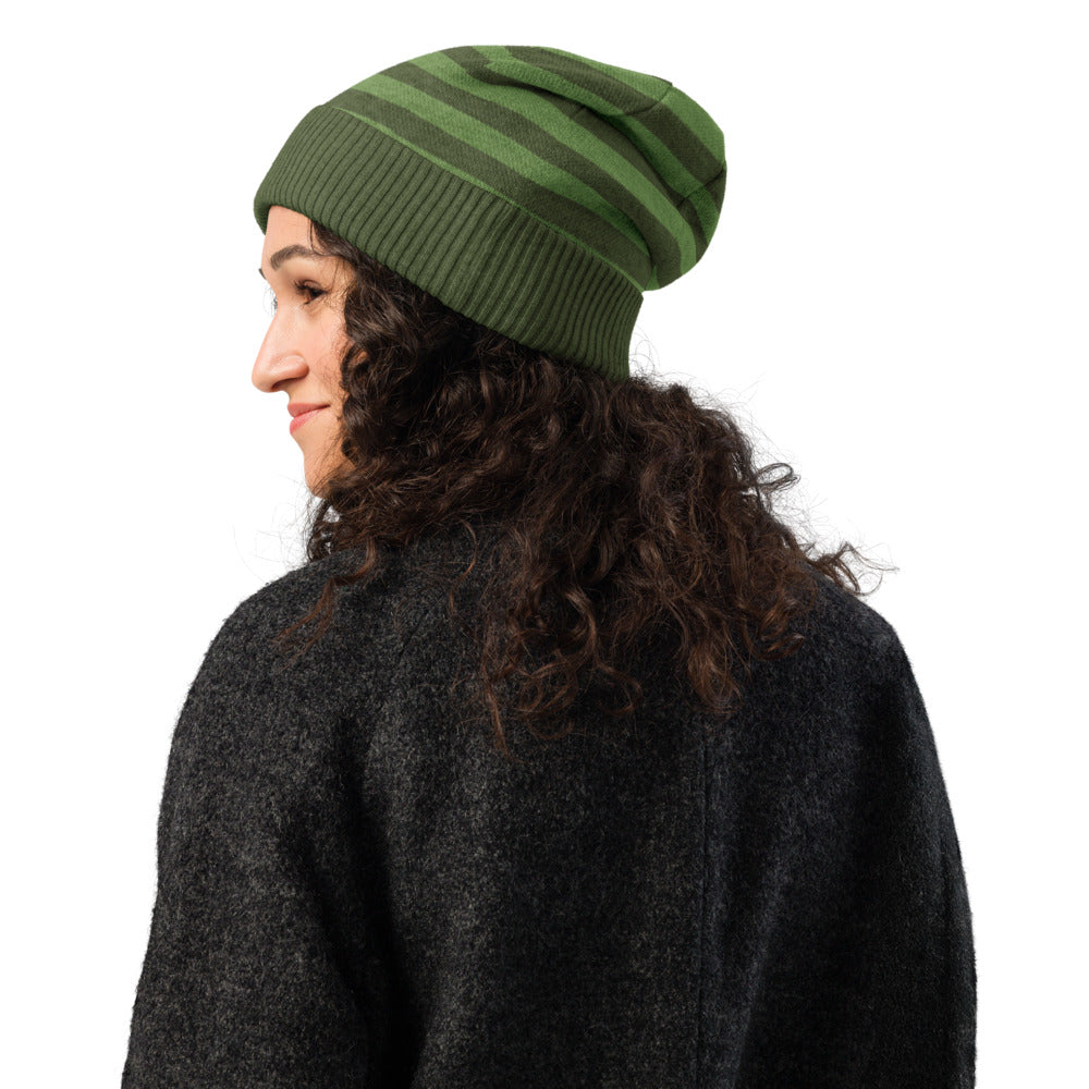 knitted beanie with a black grunge skull with x-eyes on a striped green background