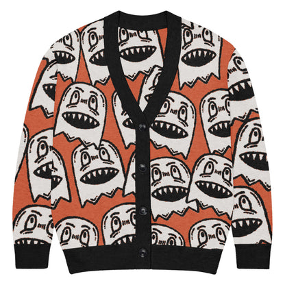 orange knitted cardigan with large grinning goblin heads in scene and grunge style