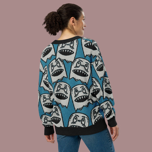 woman wearing an electric blue knitted cardigan with large grinning goblin heads in scene and grunge style