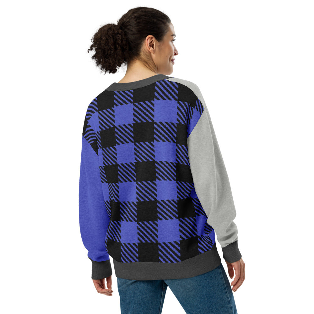woman wearing a knitted cardigan with patchwork like design, plaid, hearts, spooky eyes and a cat