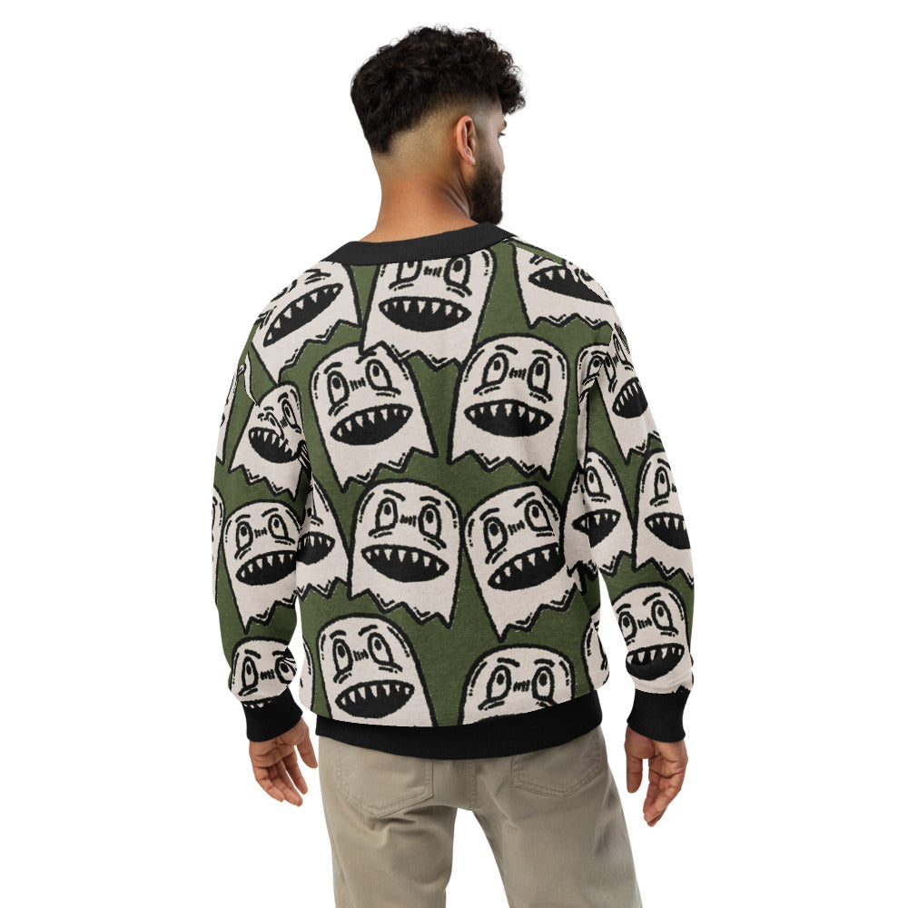 green knitted cardigan with large grinning goblin heads in scene and grunge style
