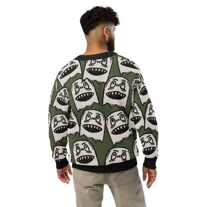 green knitted cardigan with large grinning goblin heads in scene and grunge style