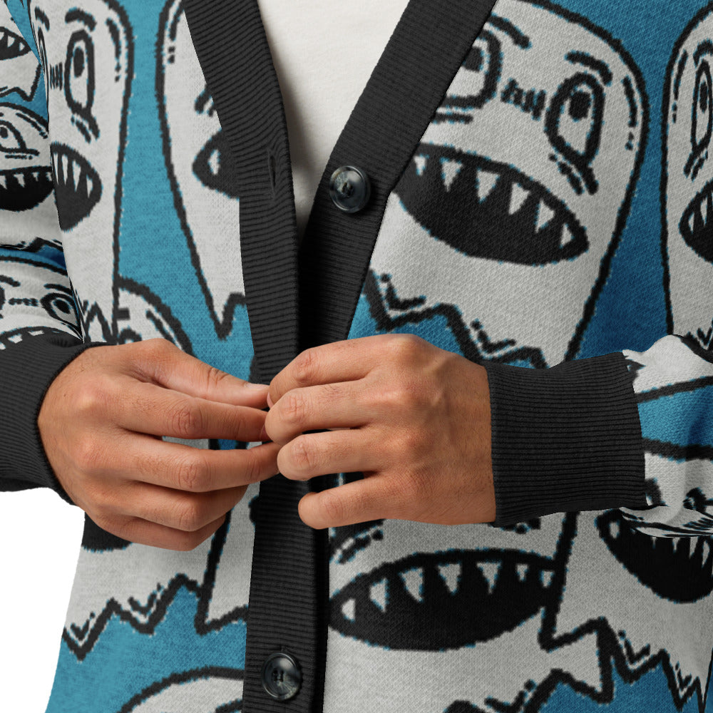 details of an electric blue knitted cardigan with large grinning goblin heads in scene and grunge style