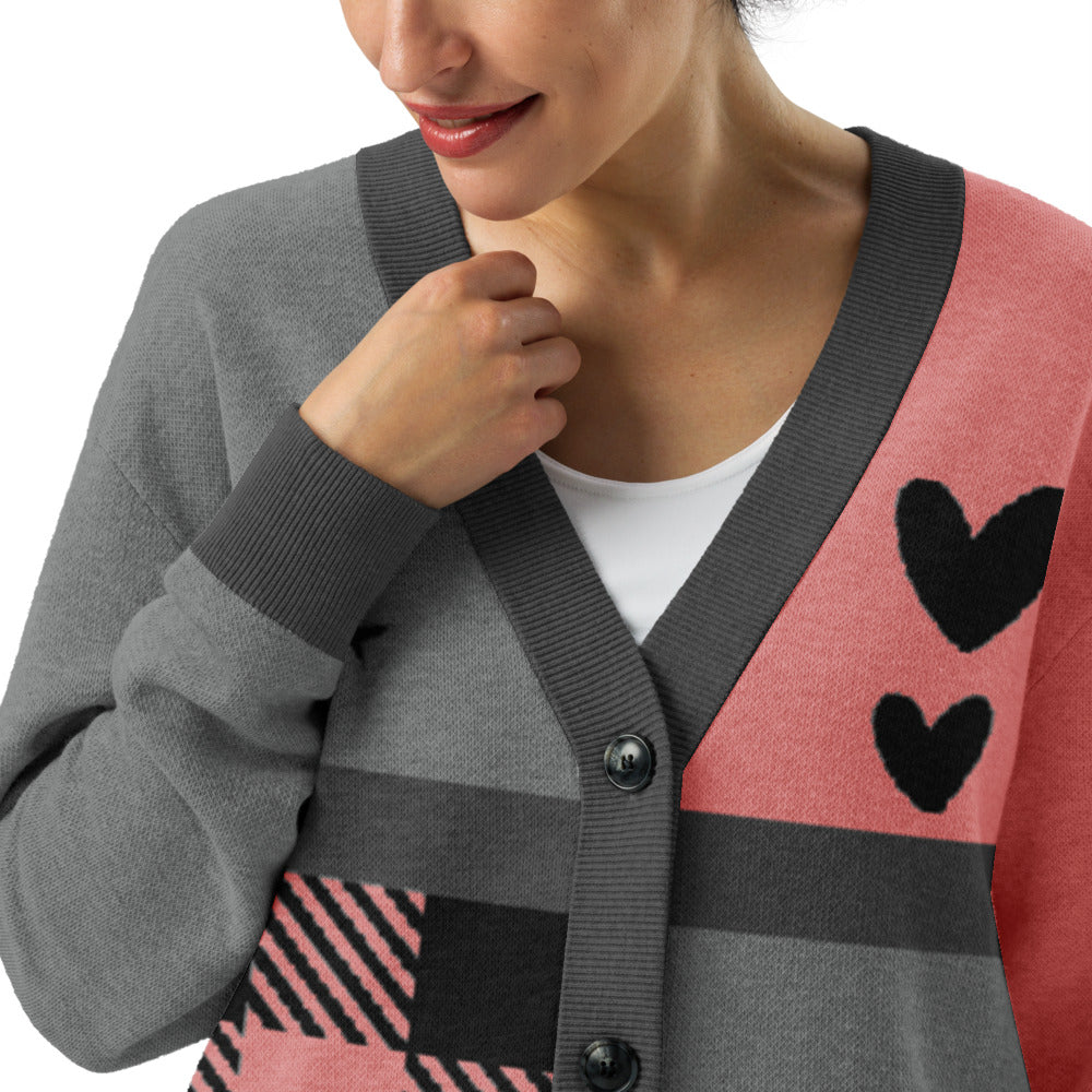 a knitted cardigan with patchwork like design, plaid, hearts, spooky eyes and a cat