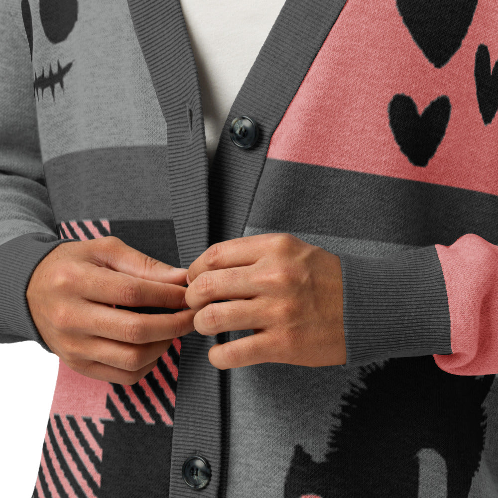 a knitted cardigan with patchwork like design, plaid, hearts, spooky eyes and a cat