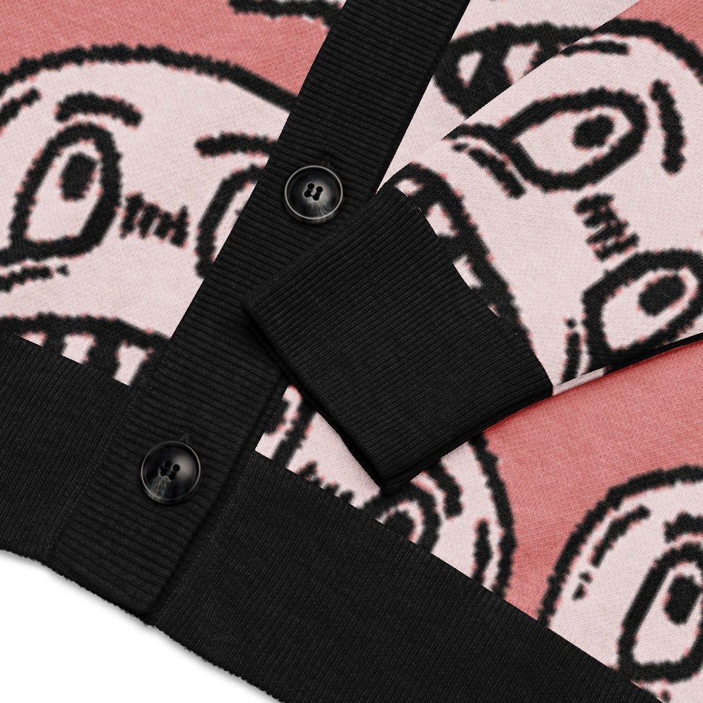 pink knitted cardigan with large grinning goblin heads in scene and grunge style