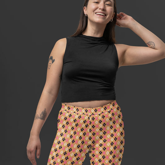 Person wearing a black top and yellow argyle patterned leggings 