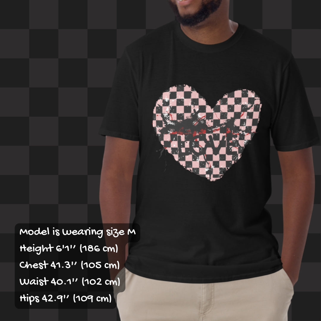 Person wearing a black t-shirt with a pink and black cracked distressed checkered heart and the text love partly obscured. Sizing info.