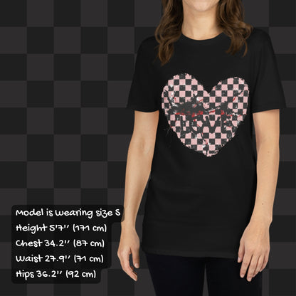 Person wearing a black t-shirt with a pink and black cracked distressed checkered heart and the text love partly obscured. Sizing info.