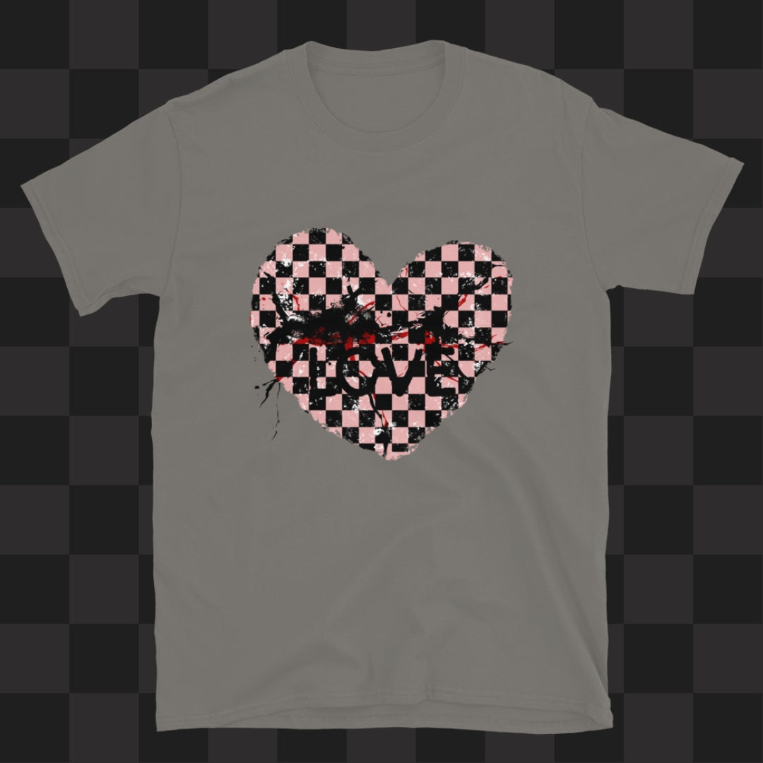 A grey gildan 64000 t-shirt with a pink and black cracked distressed checkered heart and the text love partly obscured.