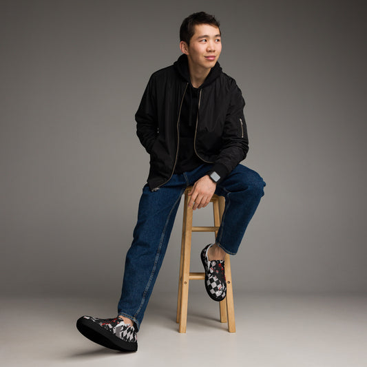 man wearing grey and black distressed checkered emo slip on shoes