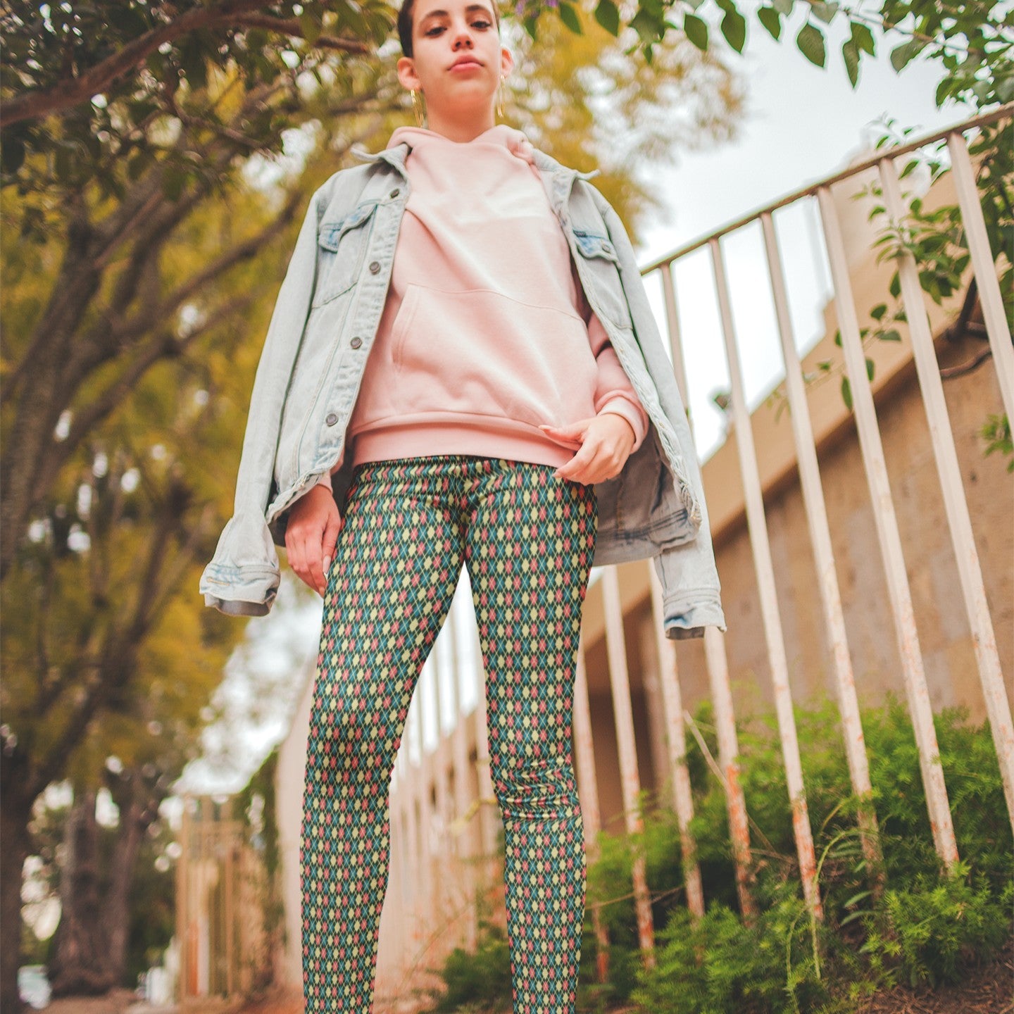 woman wearing leggings with a colorful diamond pattern