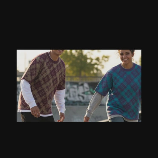 Two skaters wearing knitted tees with broken plaid pattern in cool street colors, over long sleeves