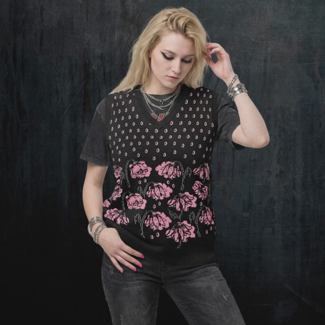 Alt style person wearing a black knitted vest with crying pink flowers and droplets product video