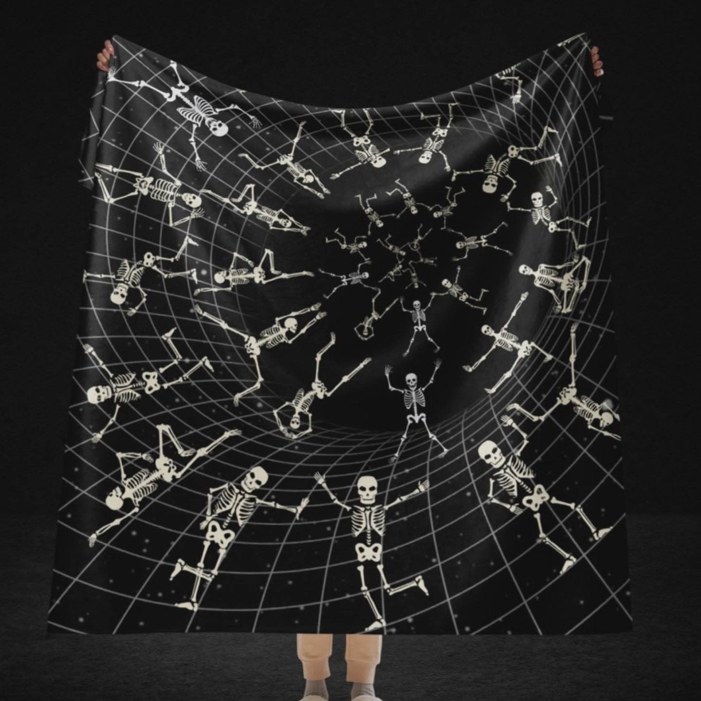 A large sherpa blanket with a vortex grid with skeletons clinging to it, falling and jumping into the void