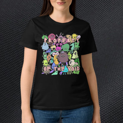 Person wearing a black t-shirt with colorful monster design and text "property of the void", and on the back side their backs