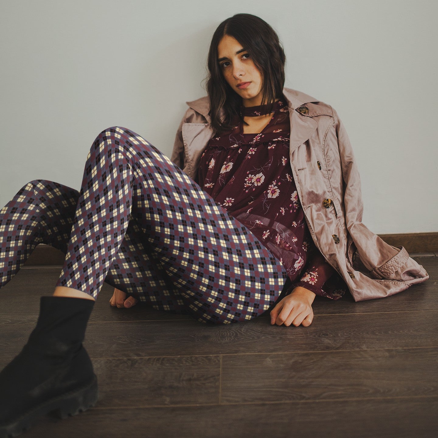 woman wearing leggings with diamond argyle pattern with purple base and burgundy accent