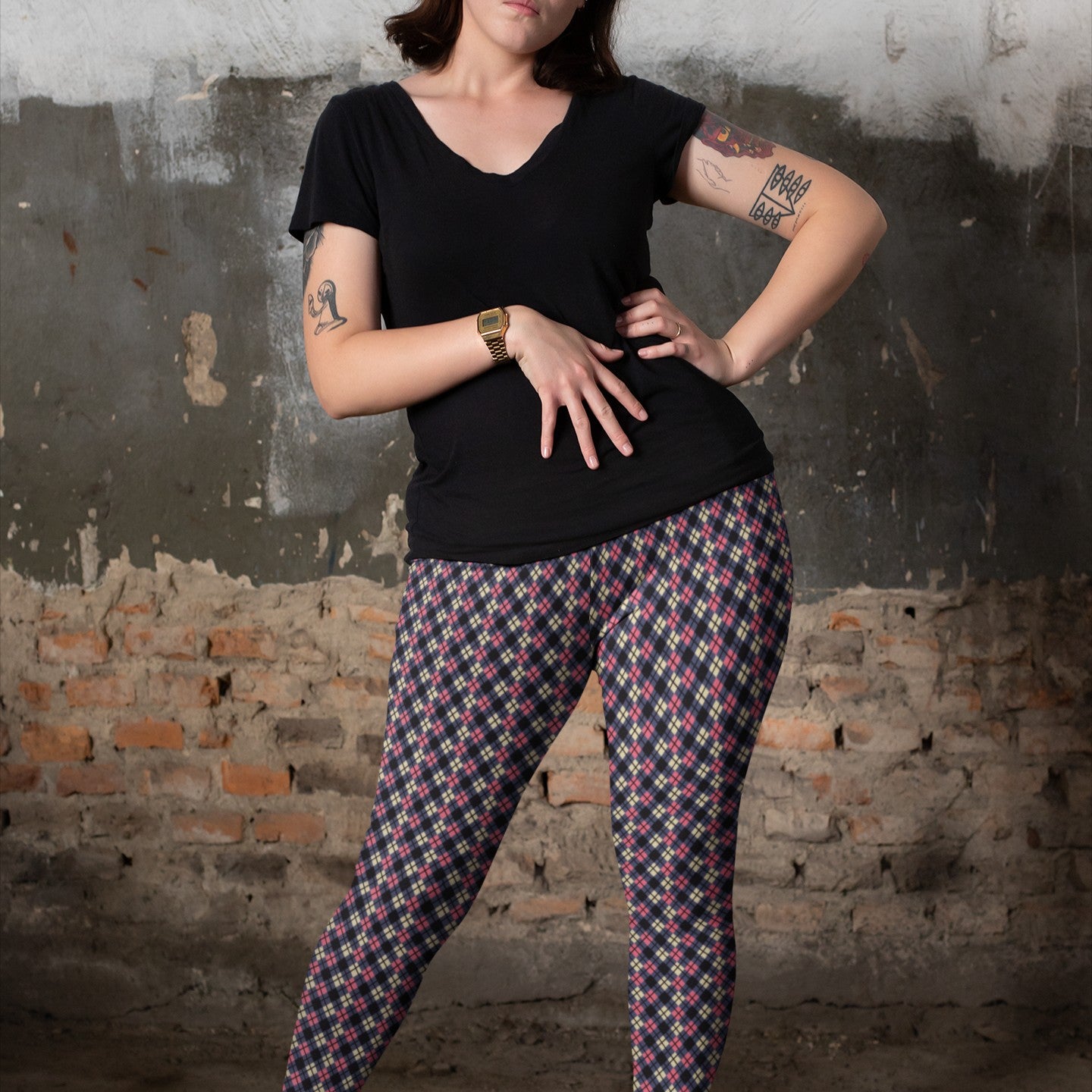 person wearing colorful argyle diamond pattern leggings with purple base and black accent