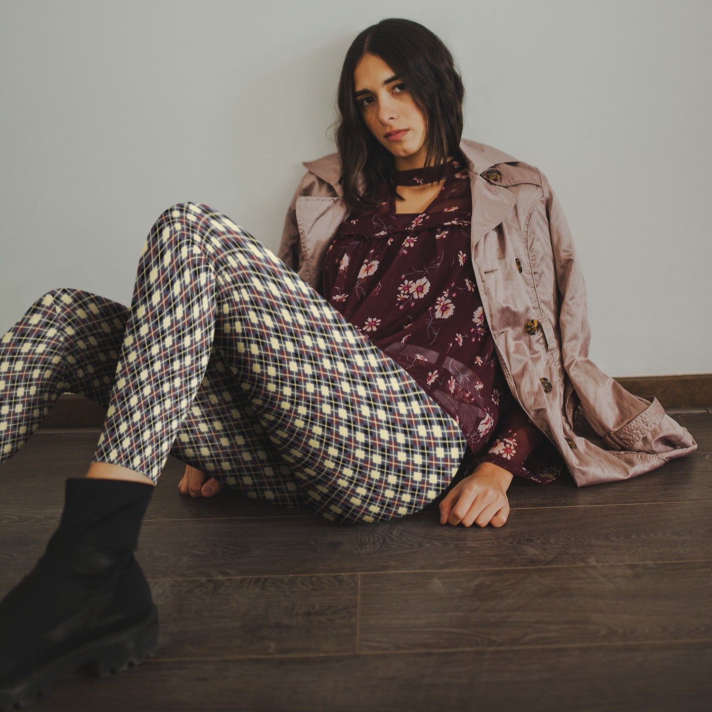 woman wearing leggings with diamond argyle pattern with purple base and beige accent