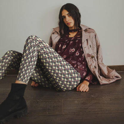 woman wearing leggings with diamond argyle pattern with purple base and beige accent