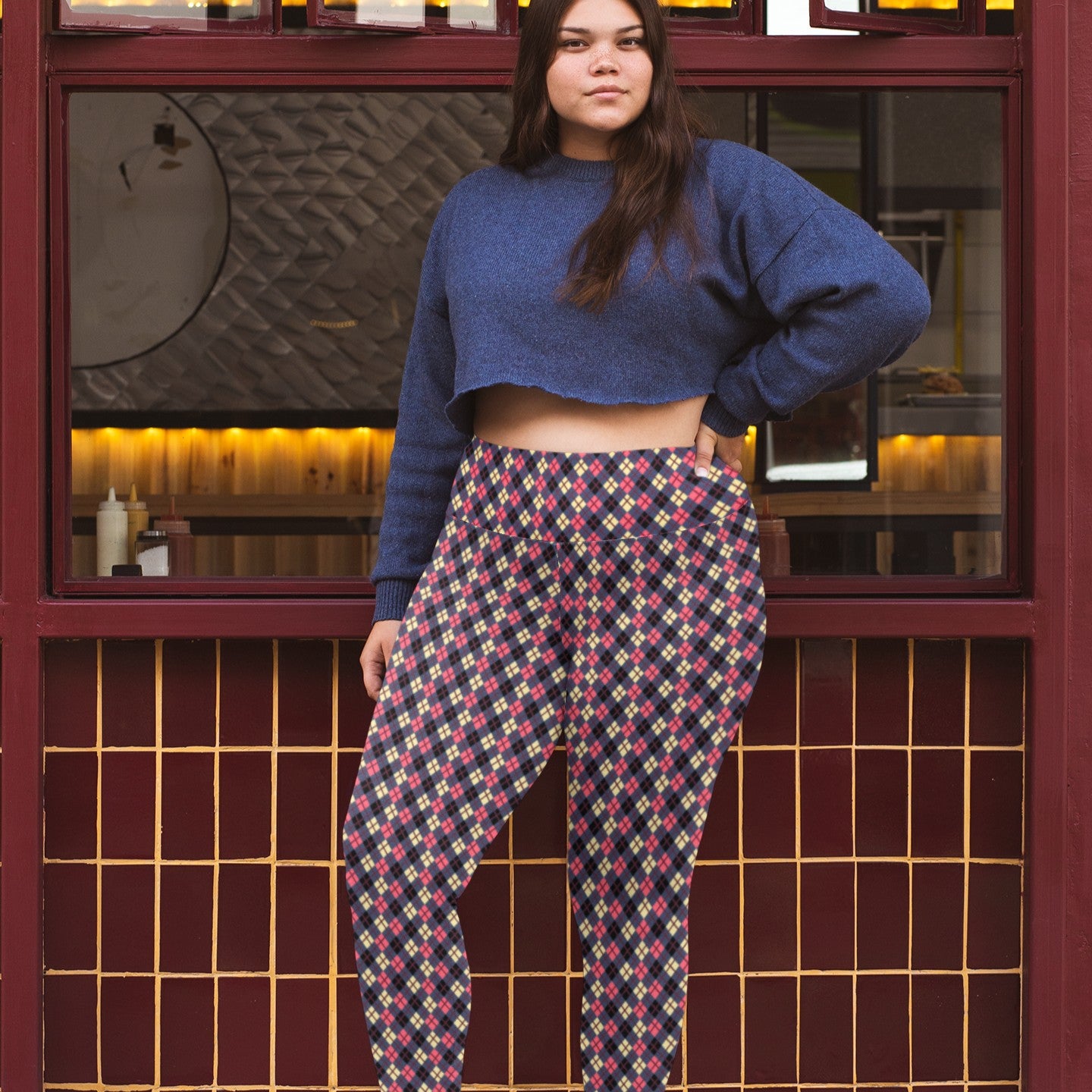 person wearing colorful argyle diamond pattern leggings with purple base and burgundy accent
