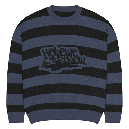 a grunge style dark striped sweater with the text "here we are now"