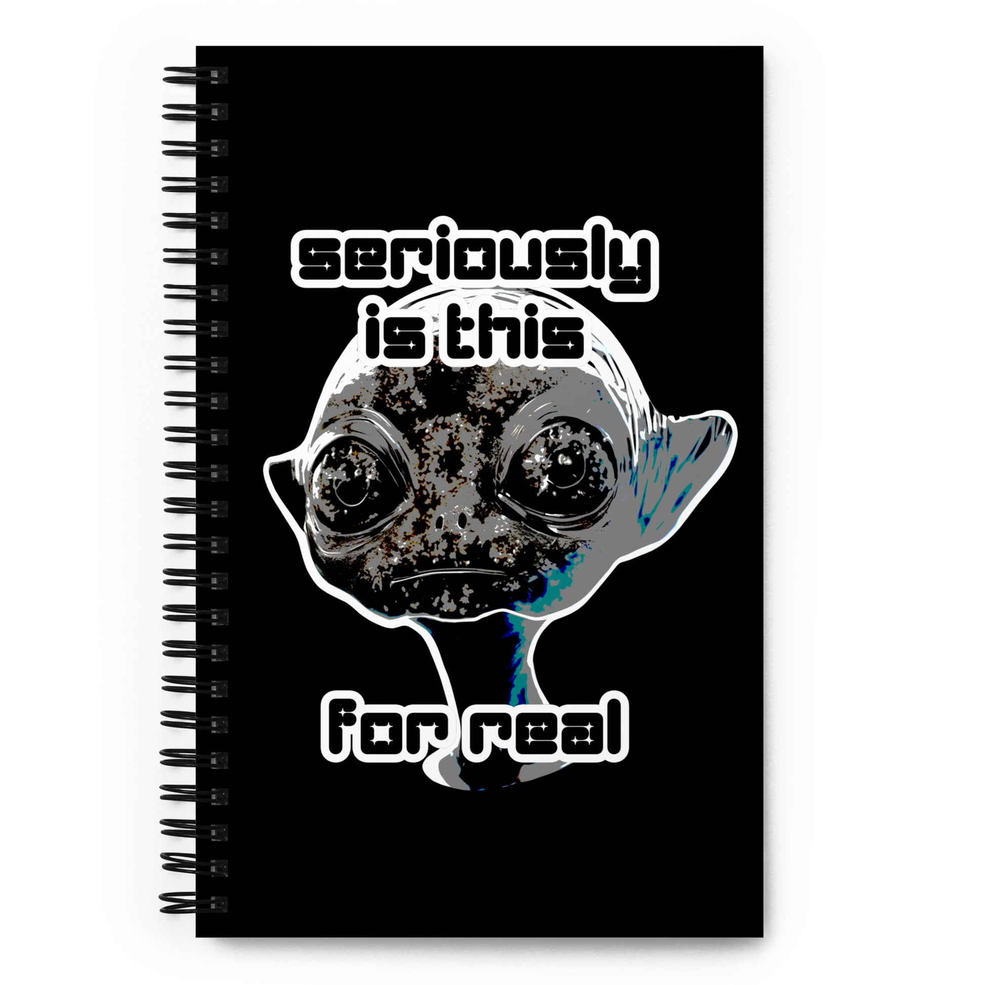 a spiral bound notebook with cover an alien and text "seriously is this for real"